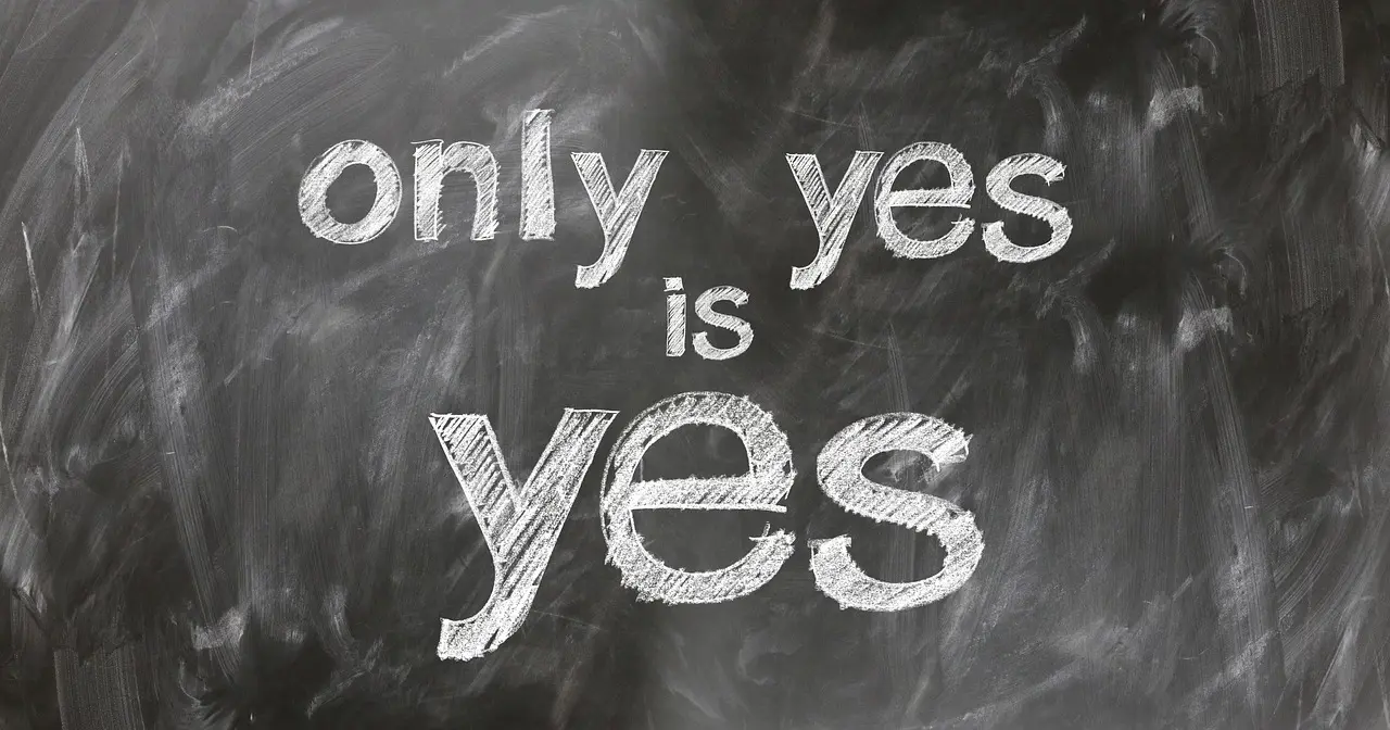 A chalkboard with the phrase 'Only yes is yes' writen on it.