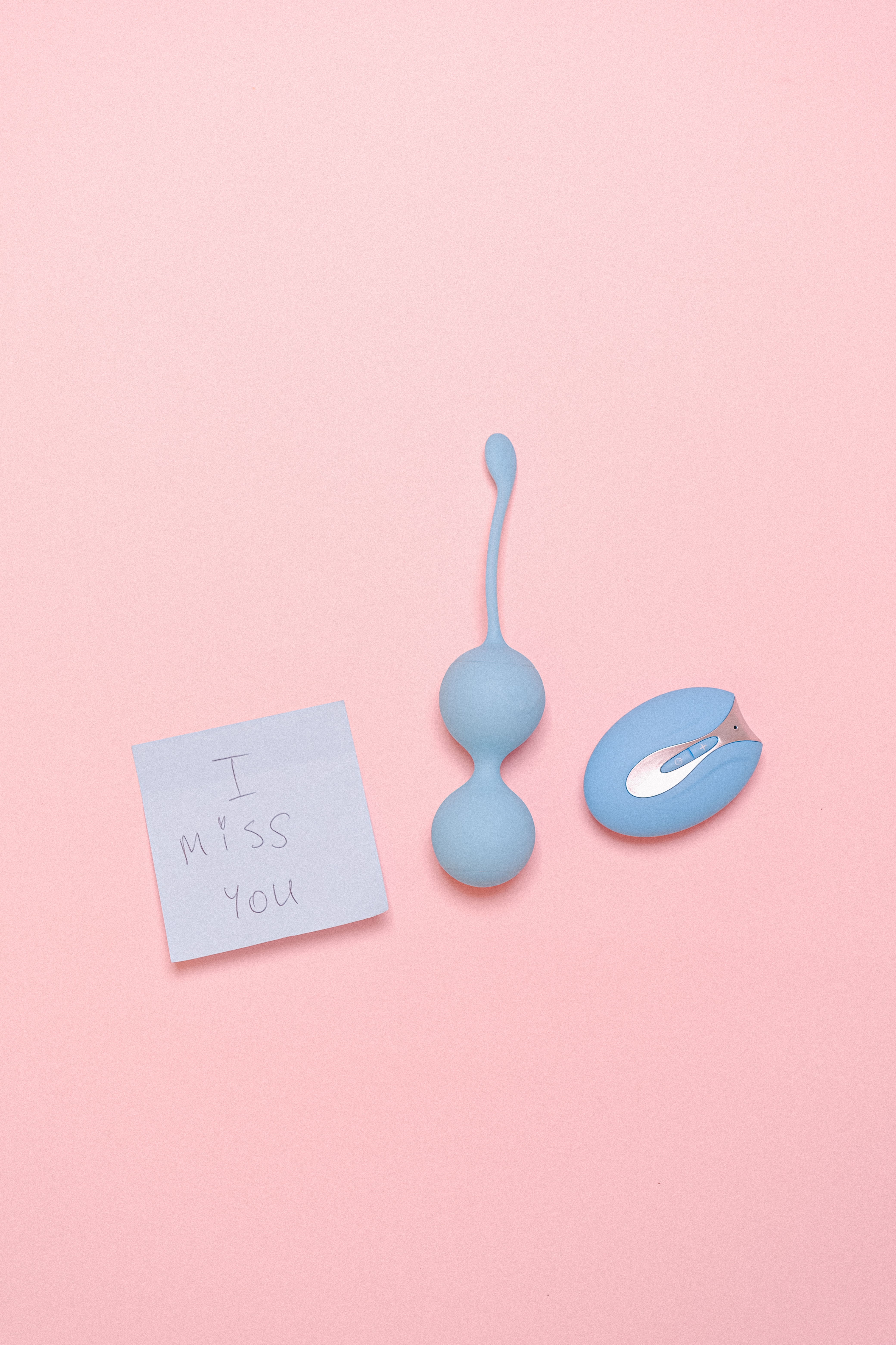 Bluetooth sex toys and a sticky note with the phrase: I miss you