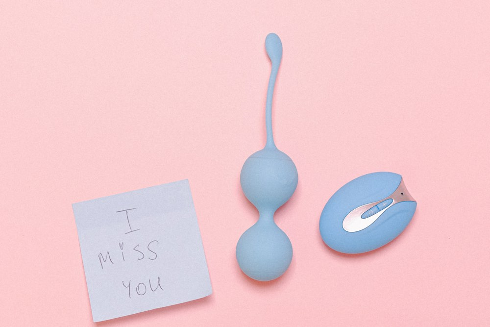 Bluetooth sex toys and a sticky note with the phrase: I miss you